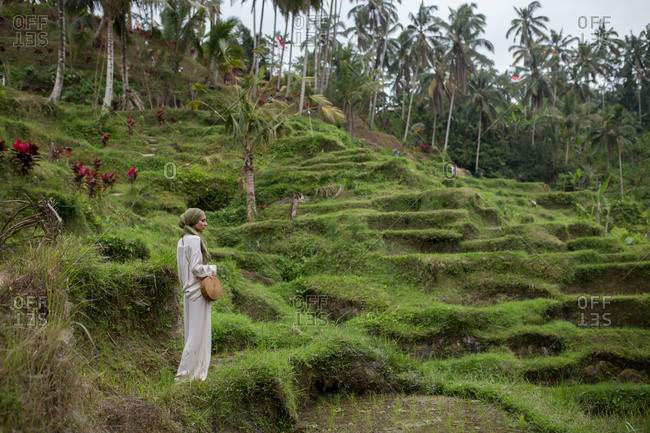Tourist woman standing in the middle of rice paddies, Bali, Indonesia