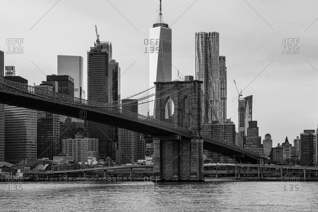 New York City, New York, USA - January 9, 2020: View of the Brooklyn bridge and buildings in lower Manhattan in black and white