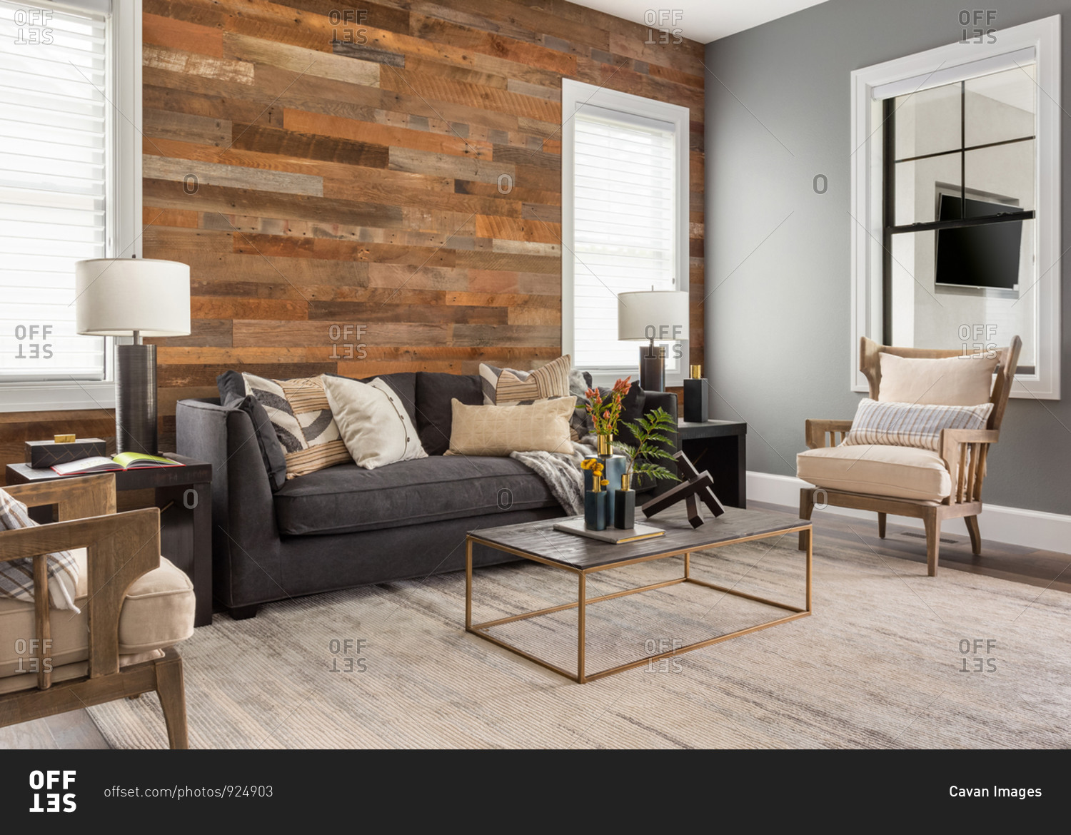 Beautiful living room in new luxury home with rustic accent wall.