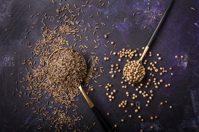 White peppercorn and cumin spice in the spoons top view