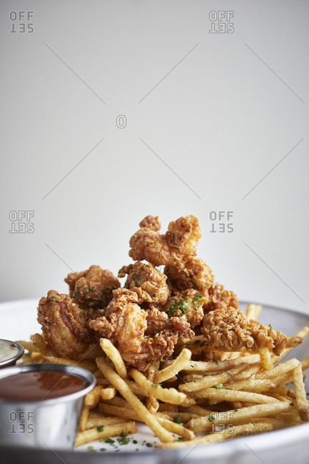 Fried shrimp on a bed of fries