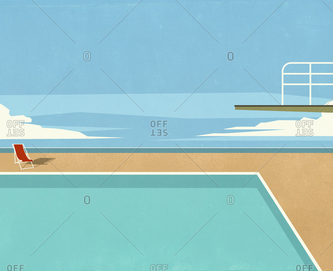 Diving board over swimming pool with ocean view