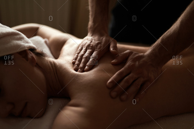 Premium Photo  Male masseur doing a lower back massage to a young