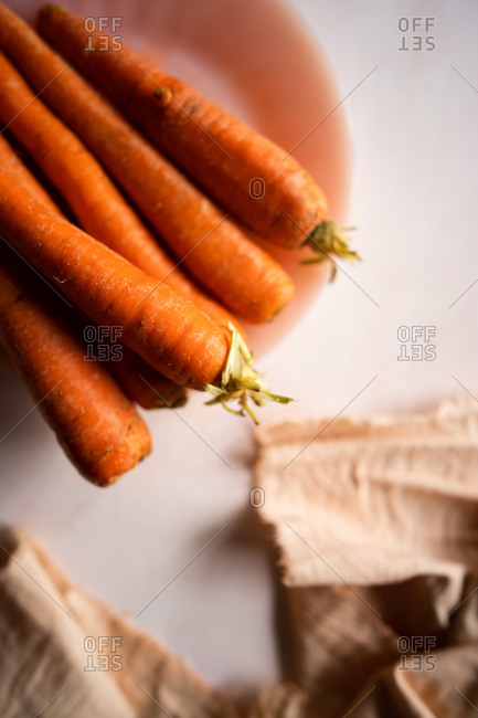Layflat of a bunch of raw carrots.