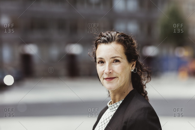 Portrait of confident businesswoman standing outdoors