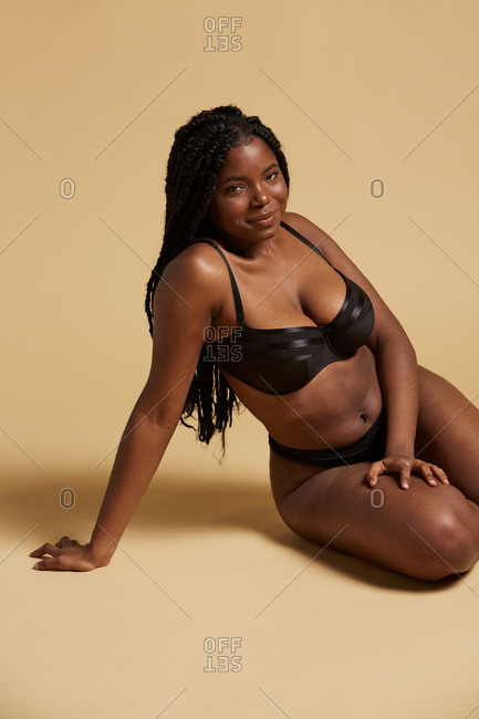 Black women in lingerie pictures Curvy Beautiful African American Woman With Braids In Lingerie Looking At Camera Sitting On The Floor Against Yellow Background Stock Photo Offset