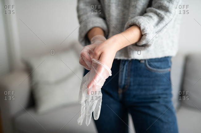 Woman putting on rubber gloves