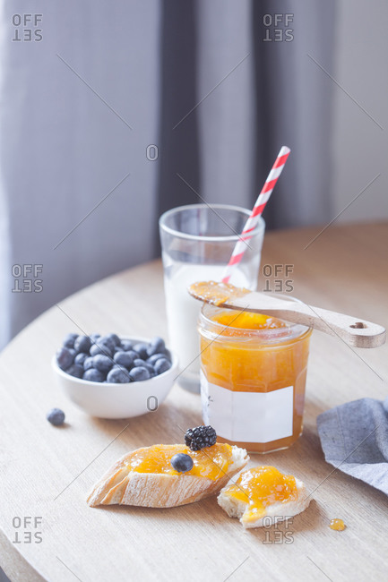 Delicious breakfast with baguette and apricot jam