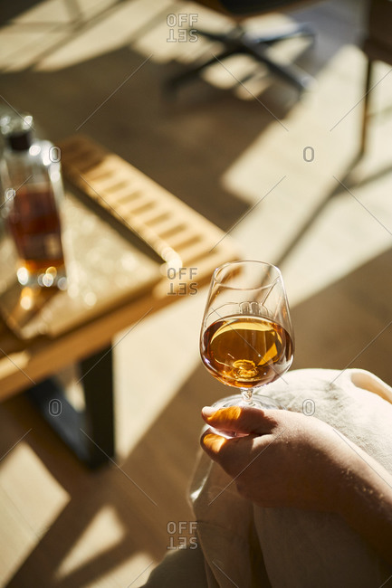 Woman holding a whisky drink