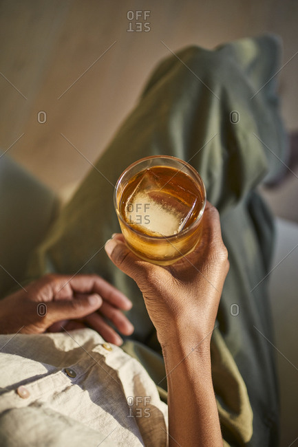 Holding a whiskey drink - Offset