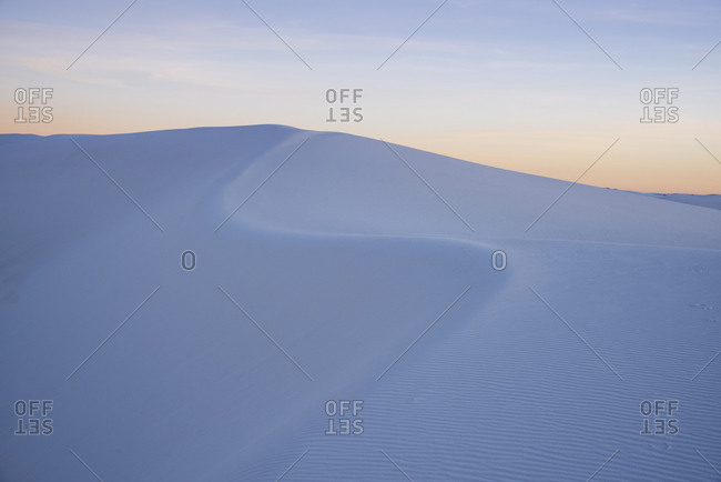The curve of a sand dune at sunset in White Sands National Park, New Mexico, United States of America, North America