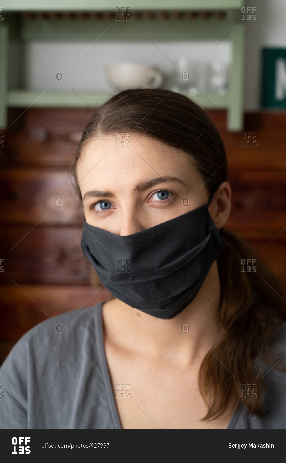 Woman puts a silk mask on her face to protect herself from the covid-19 virus