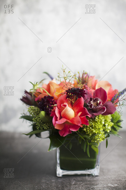 Floral arrangement with red roses and orchids