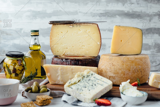 A variety of cheese and fruit with olive oil