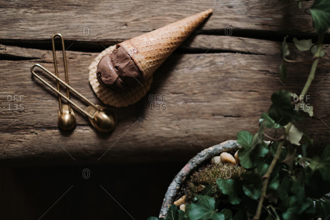 Overhead view of a chocolate scoop of ice cream in a cone on a wafer crisp