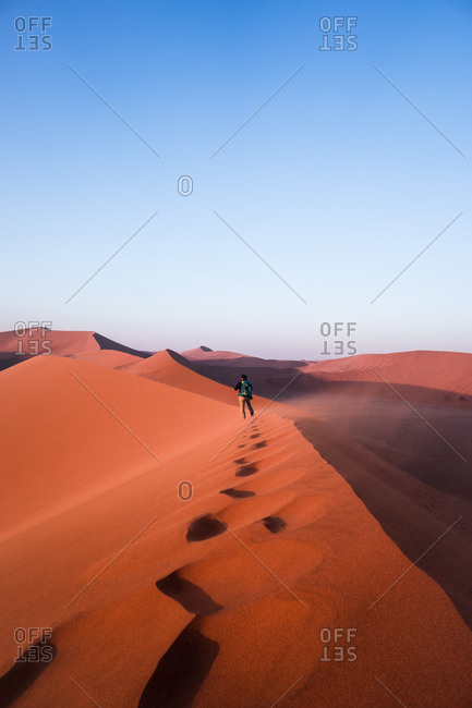 A person walking on the top of Dune 45, Namib Naukluft National Park, Namibia, Africa