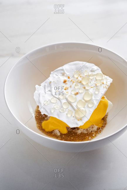Gourmet modern creative dessert with various textures - crunchy vanilla meringue, lemon gel and chia seeds