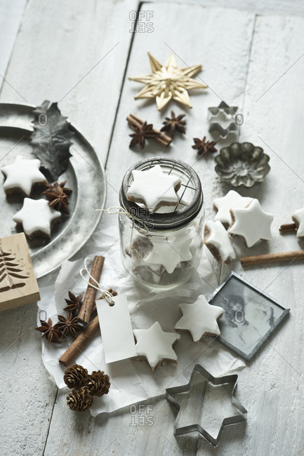 Star shaped cookies- cinnamon sticks- old photograph- pine cones- cookie cutter- star anise- glass jar and Christmas decorations