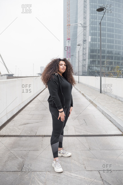 Plus size sportive young woman posing in the city