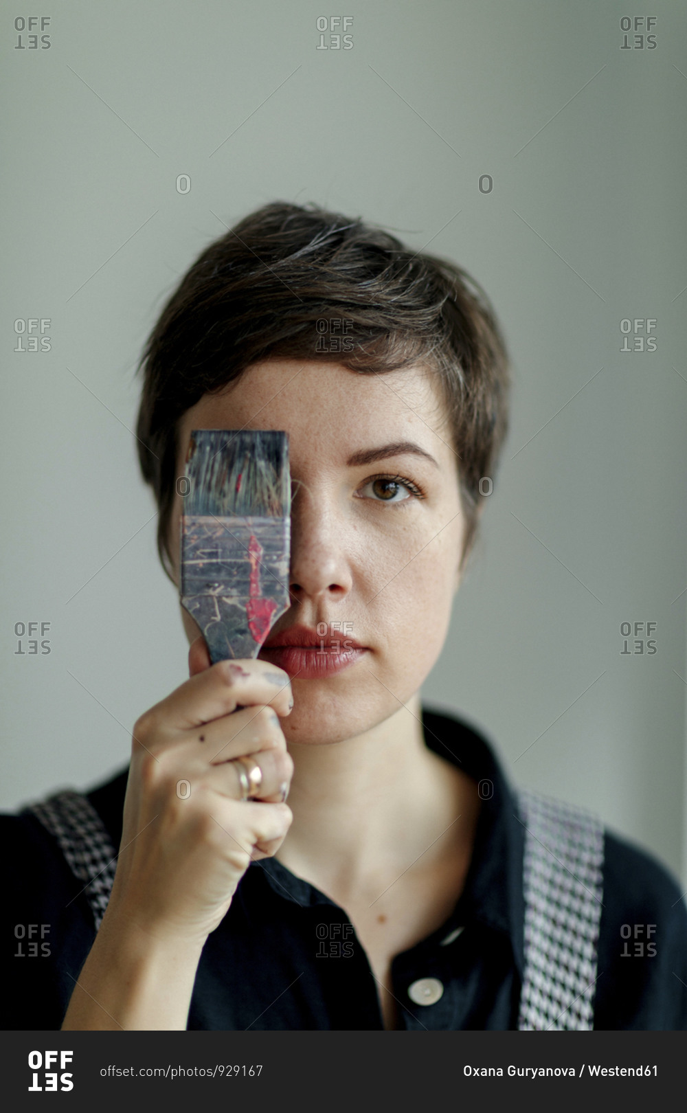 Portrait of a female painter holding a paintbrush stock photo OFFSET