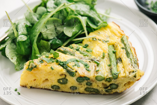Healthy asparagus frittata meal with arugula salad