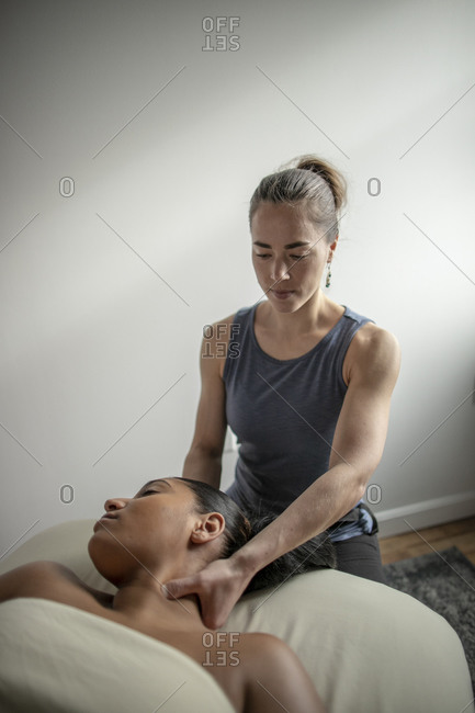 One female massages another female's neck