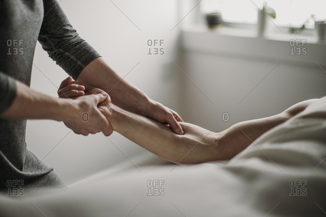Close up of massage therapist treating patient's bicep