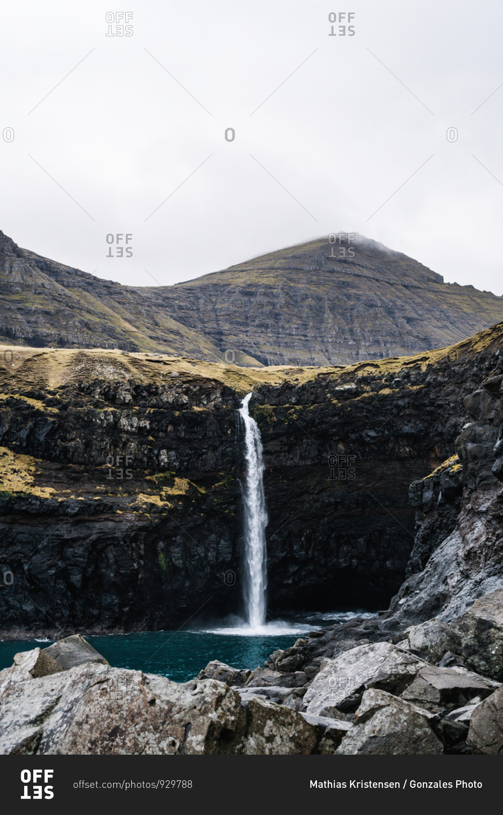 The Mulafossur Waterfall flowing over cliff at Gasadalur in the Faroe Islands
