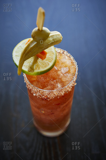 Close up of a bloody Mary with salted rim and pickled vegetables