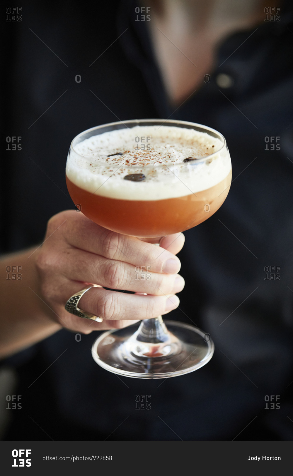 Hand holding a cocktail drink