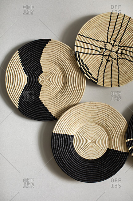 Decorative wicker plates on white surface