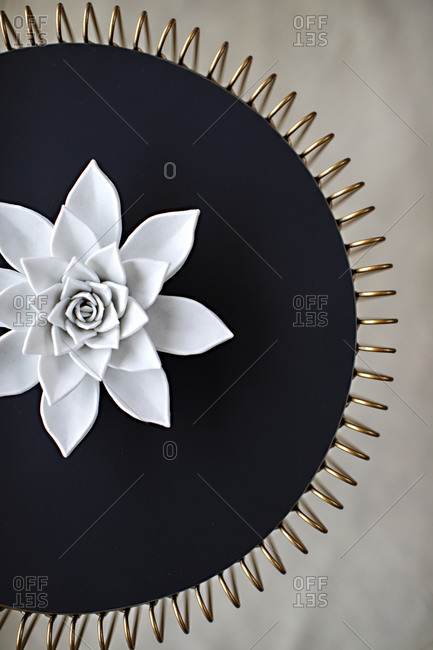 Decorative artwork with large white flower and gold edges
