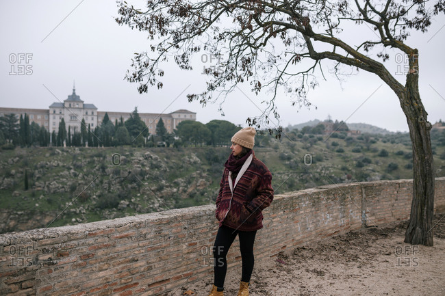 Young woman looking at the landscape of the city of Toledo in Spain