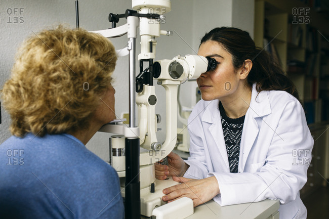 Ophthalmologist examining eyesight of a senior patient