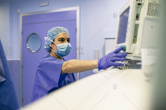 Operating room nurse checking screen