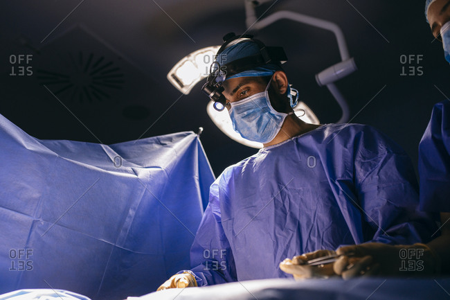 Operating room nurse and surgeon during an operation