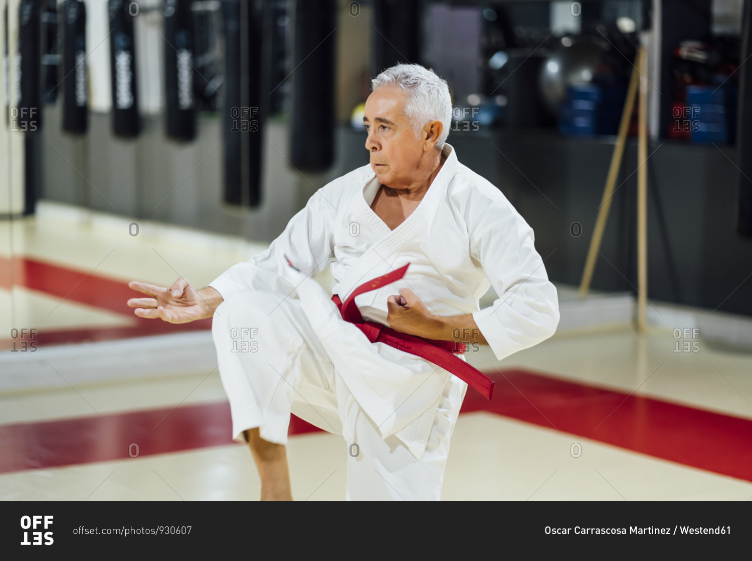 Senior man practicing karate in gym