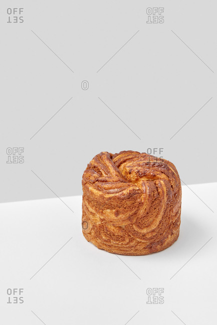 Homemade freshly baked cake on a duotone light grey background with copyspace