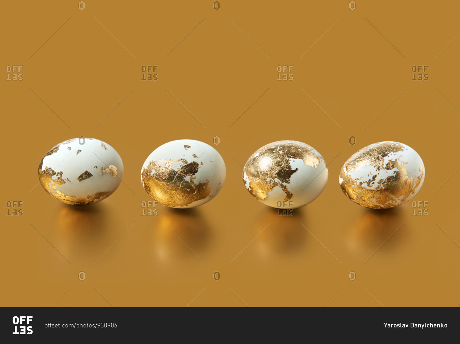 Painted golden Easter eggs on a gold background with copy space - Stock ...