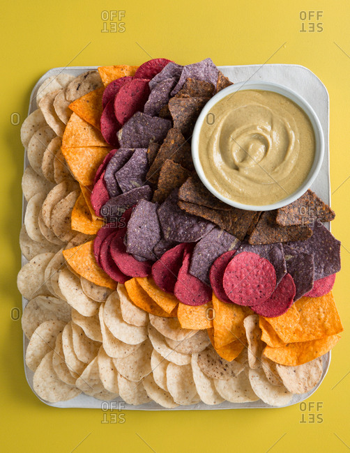 Variety of vegetable based corn chips and vegan queso dip
