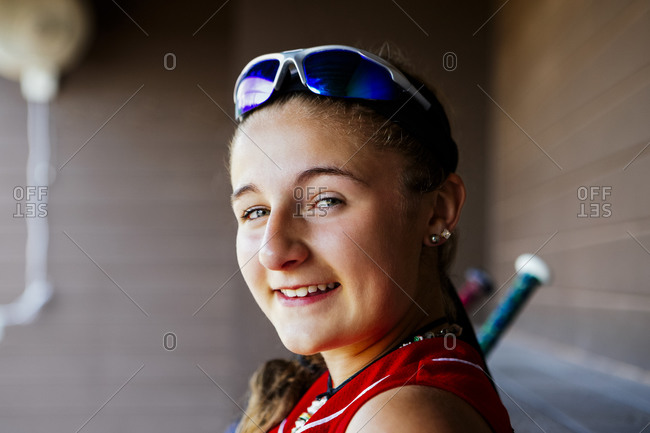 Portrait of softball player sitting in dugout