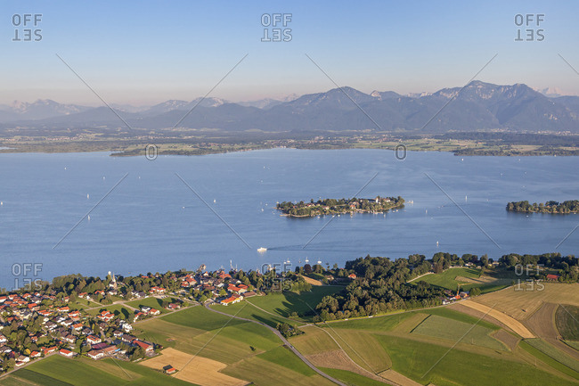Flight over the Chiemsee with a view of Gstadt behind it the Fraueninsel and Chiemgau Alps, Chiemgau, Upper Bavaria, Bavaria, southern Germany, Germany, Europe