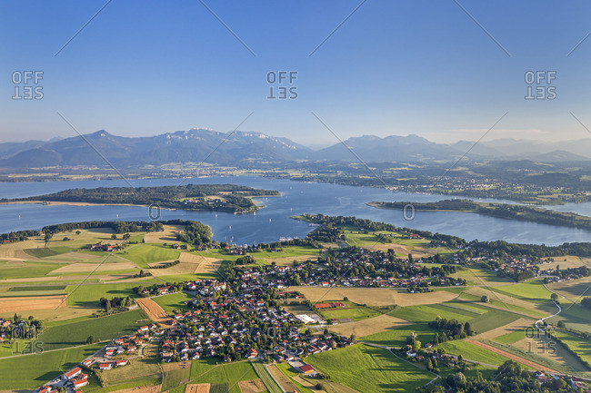 Flight over the Chiemsee with views of Breitbrunn behind the Herreninsel and Chiemgau Alps, Chiemgau, Upper Bavaria, Bavaria, southern Germany, Germany, Europe
