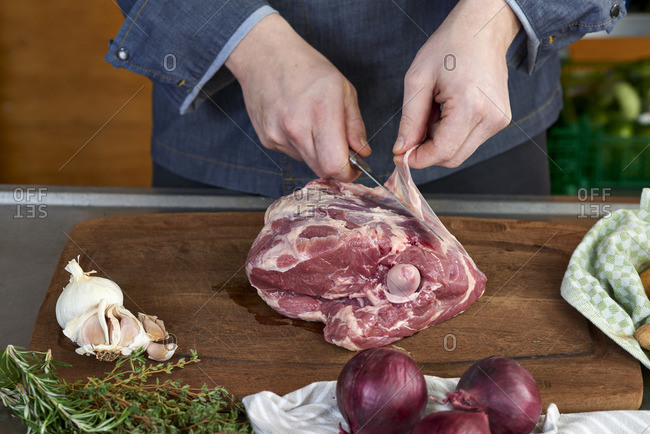 Photo series, step-by-step preparation of a leg of lamb filled with herbs and Provencal vegetables by using a food processor