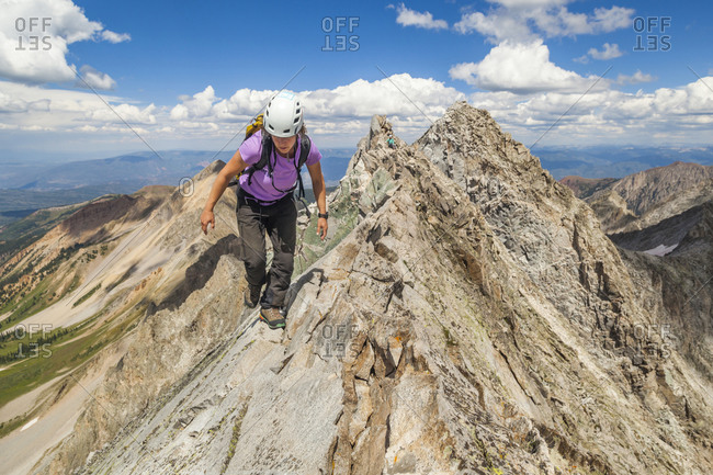 Women climb narrow ridge on Capitol Peak, Elk Mountains, Colorado