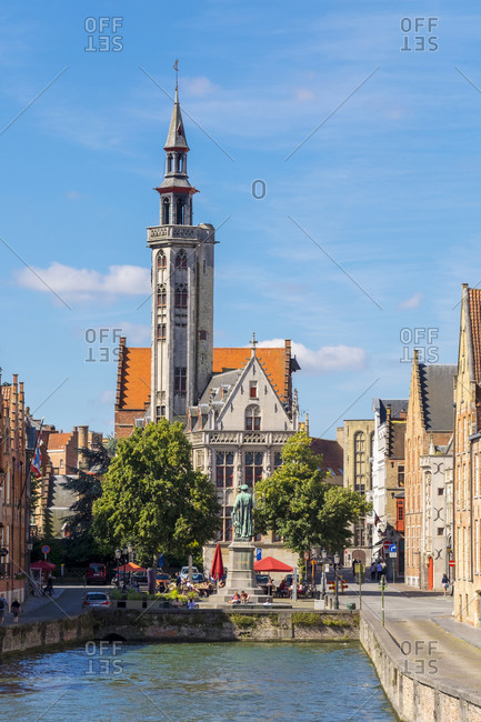 Bruges, Flanders, Belgium - August 15, 2016: The Burghers' Lodge and Jan van Eyckplein on the Spiegelrei canal, Bruges, West Flanders, Belgium