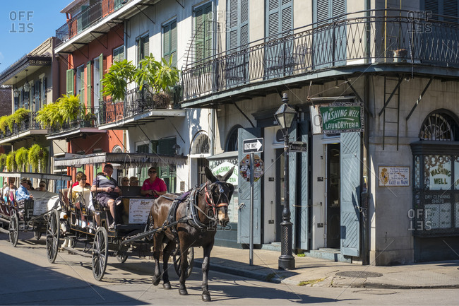 New Orleans, Louisiana, United States - October 13, 2016: Horse-drawn carriage and buildings on Bourbon St., New Orleans, Louisiana, United States