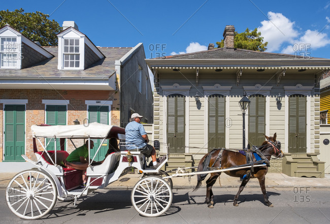 New Orleans, Louisiana, United States - October 13, 2016: Horse-drawn carriage and buildings on Bourbon St., New Orleans, Louisiana, United States