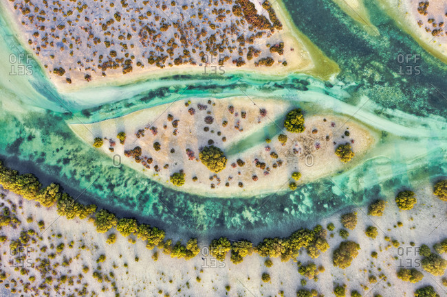 Aerial view above of stream crossing Abu Al Sayayif natural reserve, Abu Dhabi, United Arab Emirates