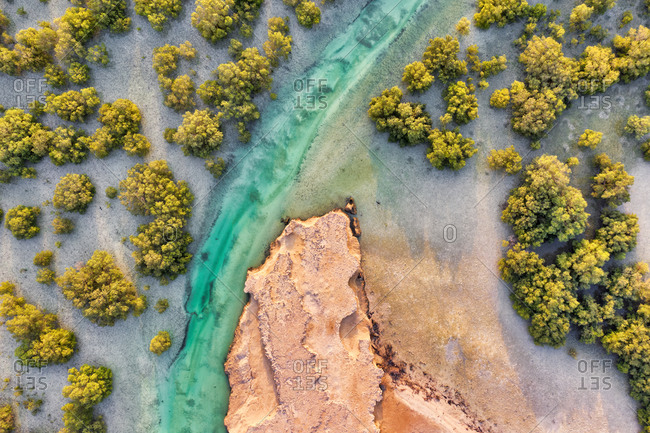Aerial view above of stream crossing Abu Al Sayayif natural reserve, Abu Dhabi, United Arab Emirates
